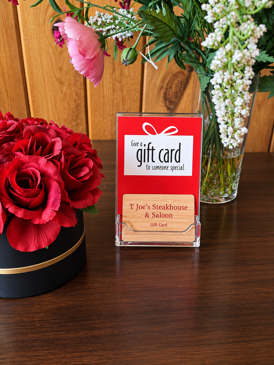 T-Joe's Steakhouse & Saloon gift card display with red branding and wood accent card
